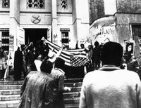 대사관 앞에서 성조기를 거꾸로 펼치는 학생 단체