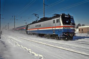 A boxy silver locomotive in snow