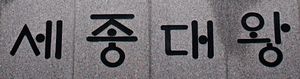 世宗大王}}이라고 적혀 있으며 세종이 처음으로 공포한 문자의 형태를 보여줍니다. 모음에 있는 점, 처음 두 음절의 'ㅅ'과 'ㅈ'의 기하학적 대칭, 세 번째 음절의 'ㄷ' 왼쪽 상단의 비대칭적인 입술 모양, 마지막 음절의 초성과 종성 'ㅇ'의 구분에 유의하십시오.