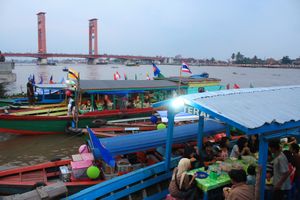 떠 있는 와룽(warung) 배에서 현지 음식을 즐기는 사람들