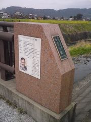 우키하정 다카미에 있는 「엘리슨 오니즈카 교」 하류 쪽 기둥에 설치된 교량명 플레이트와 엘리슨 오니즈카의 약력을 적은 설명판(2009년 3월 19일 촬영)