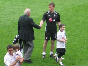 2008년 5월 알파예드가 풀럼의 득점자 브라이언 맥브라이드(Brian McBride)를 축하하는 모습