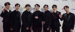 An image of GOT7, all wearing a black suit.