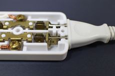 멀티탭 내부 모습. 플러그의 금속판을 구리 박판 스프링이 고정하고 있다.