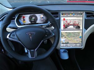 The steering wheel, dashboard, and touchscreen of a Model S