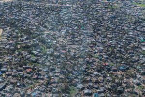 황폐해진 건물들이 펼쳐진 항공 사진. 벽은 남아 있지만 많은 건물의 지붕이 무너져 내렸습니다.