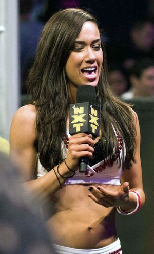 AJ Lee holding a microphone addressing the crowd