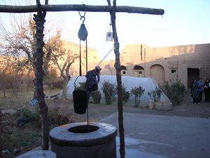 아프가니스탄 헤라트 근처 전통 주택 단지. 지하수 공급 우물(전경)이 움푹 파인 화장실(흰색 온실 뒤편)과 가까워 지하수 오염으로 이어짐