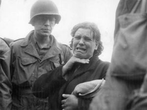 폴란드 여성이 나치 치하에서 강제 노동자로 살았던 이야기를 미국 군인들에게 말하며 울고 있다. 그녀는 아우크스부르크가 미국에게 함락되었을 때(1945년 4월 23일) 해방되었다.