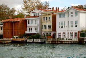 Two- and three-story colored houses with docks and balconies, built directly on the edge of the water