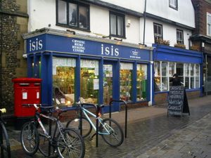 New Age store along stone street with bicycles parked out front and large crystals behind display windows