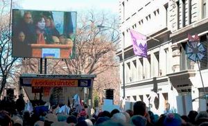 기념식에서 연설하는 미국 노동부 장관 힐다 솔리스. 브라운 (아슈) 빌딩이 오른쪽에 보인다.