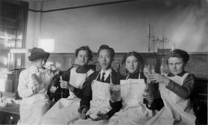 1914년 네브라스카 주립대학 화학 실험실에서 여학생들과 남긴 기념사진 (왼쪽)