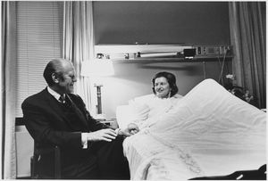 포드 대통령이 1974년 10월 2일 베세즈다 해군 병원에서 유방 절제술 후 회복 중인 베티의 침대에 앉아 있다.