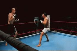 Professor Barrãozinho from Axé Capoeira performing a meia-lua de compasso against Keegan Marshall.