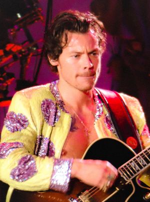 리우데자네이루에서 열린 2022 Love on Tour 콘서트에서 가슴골이 드러나는 재킷을 입고 있는 뮤지션 해리 스타일스