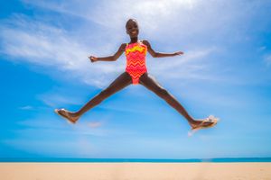 Girl wearing a pink and orange swimsuit