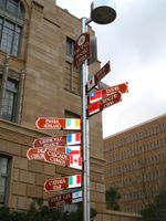 photo of signpost with ten signs pointing in the direction of Phoenix's sister cities, stating their names and distances from Phoenix.