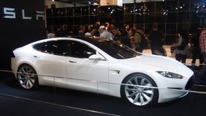 A front three-quarters view, taken indoors, of a Tesla Model S prototype.