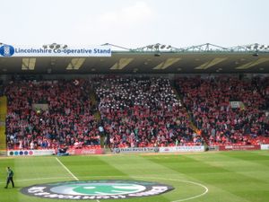 링컨 팬들이 스윈던과의 경기 전 카드 섹션을 펼치고 있다