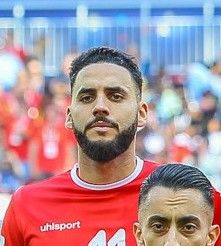 딜랑 브론이 2018년 FIFA 월드컵에서 튀니지 국가대표팀 유니폼을 입고 경기장에 정렬해 있다.