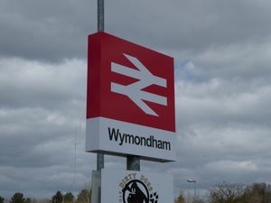 윔엄 철도역의 기차역 표지판. 이중 화살표 로고가 보인다.