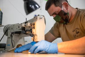 로드아일랜드 주 방위군 군인들이 COVID-19 팬데믹 기간 동안인 2020년 4월 6일에 천 마스크를 꿰매고 있다.