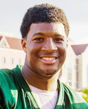 A picture of Jameis Winston while shaking someone's hand.