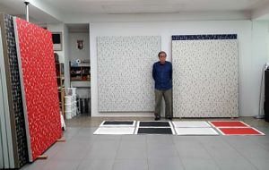 Young posed in front of Plane Conditions and Fingerprints in the studio