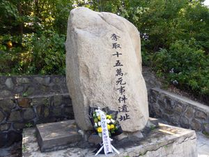 헌화되어 있는 15만 엔 강탈 사건 유적비