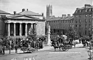 Market held in front of Dundalk Courthouse with Maid of Erin statue to front and bell tower of St Patrick's Church visible in background, c. 1906