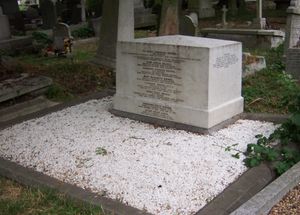 A cubical white marble work of masonry, approximately three feet wide, 18 inches deep and two feet high, inscribed with names of members of the Brunel family, surrounded by marble chippings