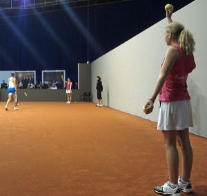 선수에게 공을 제공하는 포즈를 취한 두 명의 볼 걸