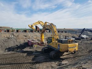 오염된 폐기물로 채워진 파이프 조각을 제거하는 대형 불도저