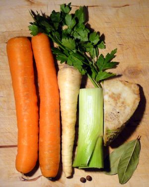 włoszczyzna}} (당근, 파슬리 뿌리와 잎, 부추, 샐러리악)이다. 월계수 잎과 올스파이스 열매도 보인다.