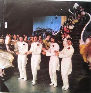 "'Your Mother Should Know" 장면의 책자 스틸 컷. 매카트니가 검은 카네이션을 착용한 반면, 레논, 해리슨, 스타는 빨간 카네이션을 착용했는데, 이는 폴은 죽었다 음모론 지지자들에게 단서가 되었다.