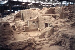 Excavation into rock showing doors and windows among the rubble.