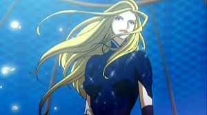 젊은 금발 여성의 상반신 애니메이션. 바디 수트와 장갑을 착용하고 있다. 그녀의 머리카락은 길고 왼쪽으로 움직이는 것처럼 보인다.