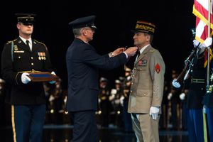 피에르 드 빌리에 장군이 미국 해군 의장대가 경례하는 가운데 공로 훈장을 받고 있다 (2017년 2월 6일).