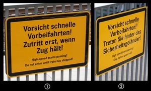 파울리네나우에 역의 표지판. 표지판 1은 안전한 면을 향하고, 표지판 2는 열차가 운행 중일 때 승객이 허용되지 않는 펜스의 선로 쪽에 있다.