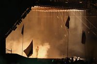 Kanye West performing at the 2015 [[Glastonbury Festival]].