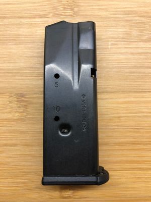 SIG Sauer P365 XL용 탄창. 제조사에서 12발이 아닌 10발로 용량을 제한하도록 수정되었다. 10발 관찰 구멍 바로 아래에 보이는 압착으로 인해 매사추세츠주의 고용량 탄창 금지를 준수하도록 용량이 제한되었다.