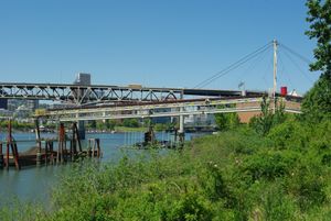 Conveyor belt loading debris onto a barge as part of the Big Pipe Project
