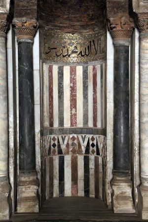 모스크의 주요 미흐라브. 키블라 벽 중앙에 위치하며 대리석, 스투코, 벽돌, 모자이크로 장식되었다. 쿠피체로 샤하다가 새겨져 있다.