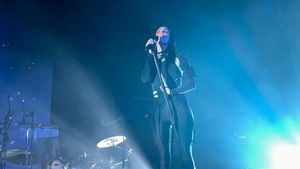 Polachek singing onstage into a microphone