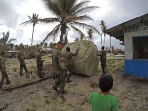 미국 육군 병사들이 추크 주의 로어 모틀록 제도에서 퍼시픽 파트너십 2019의 일환으로 물탱크를 옮기고 있다.